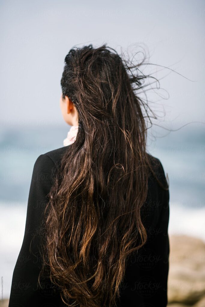 Một cô gái quay lưng nhìn ra khung cảnh mênh mông của biển