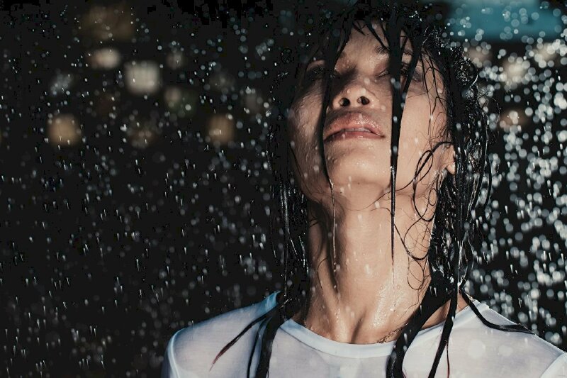 Hình ảnh cô gái đi dưới mưa mang đến một cảm giác lãng mạn và sự tận hưởng của những giọt mưa.
